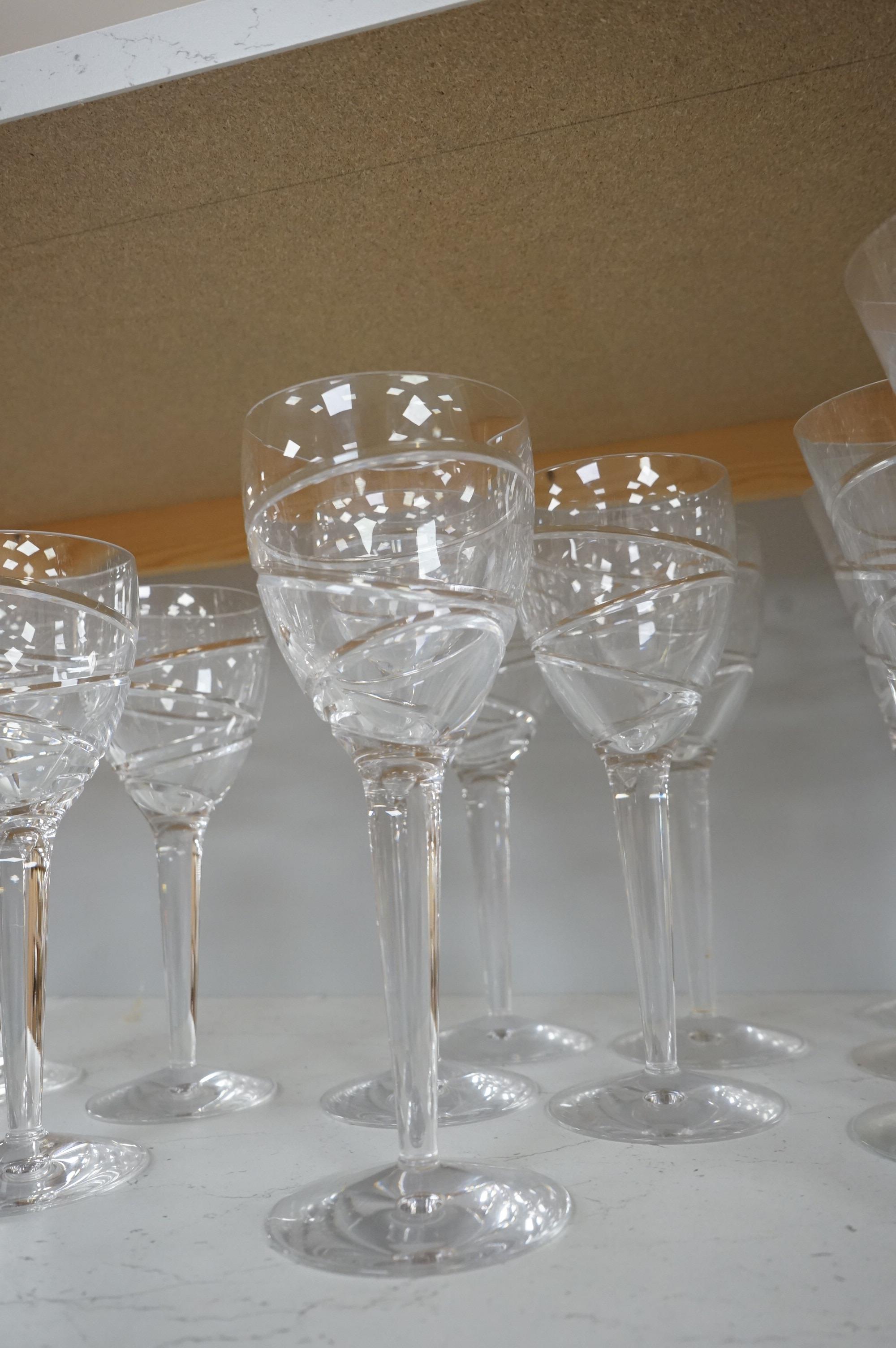 Various part suites of Jasper Conran hand cut Stuart Crystal ‘Aura’ glasses. Including eight Champagne, five large wine and six smaller wine glasses and a carafe, largest 27cm high